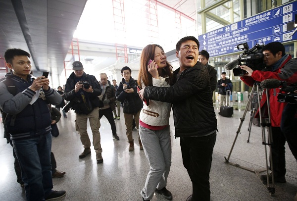 A relative of a passenger onboard Malaysia Airlines flight MH370 cries at the Beijing Capital International Airport